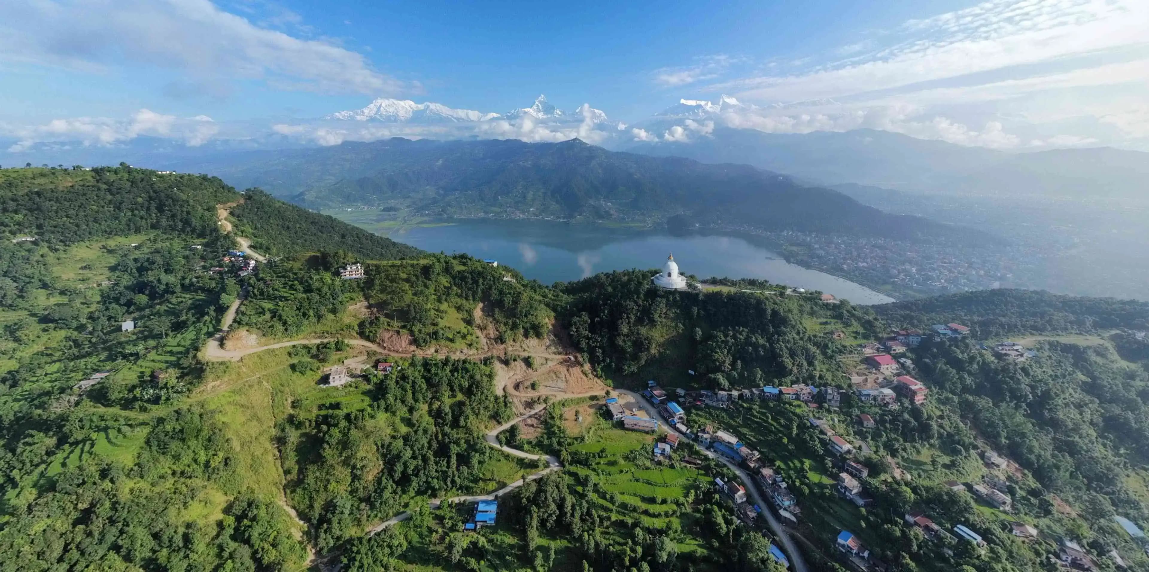 world peace pagoda, tiny settlements on the hillside of Pokhara with serene fewa lake in the backdrop